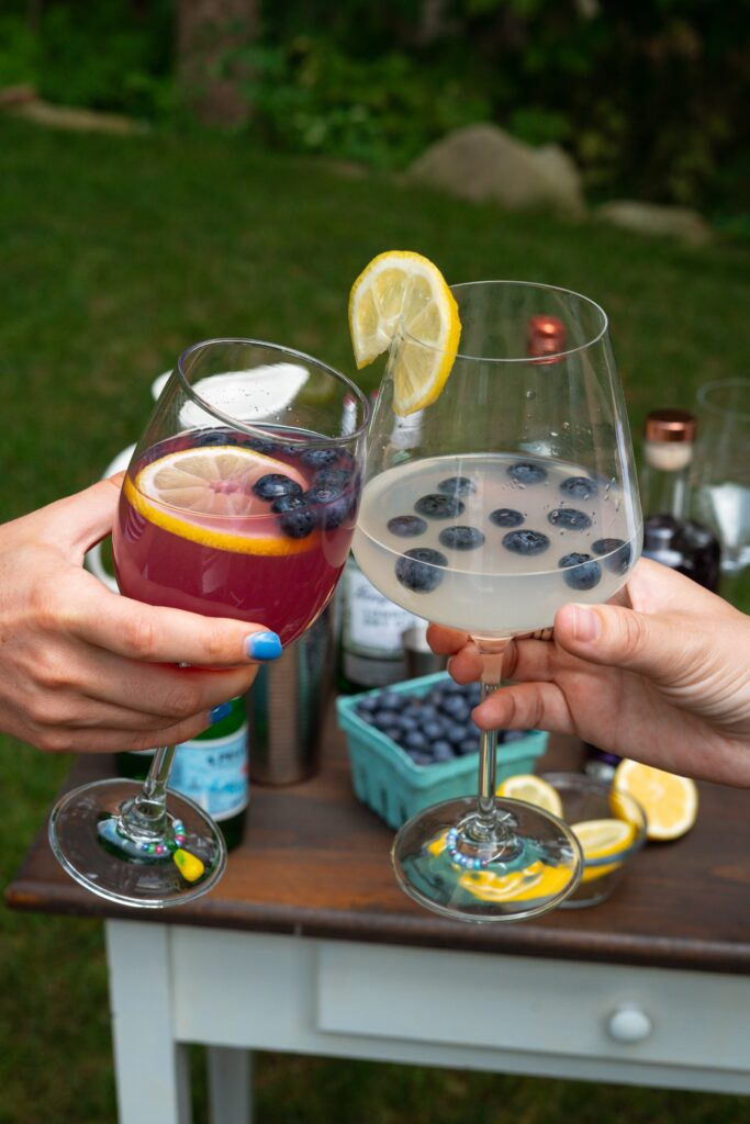 contact us - image of two people touching wine glasses together.